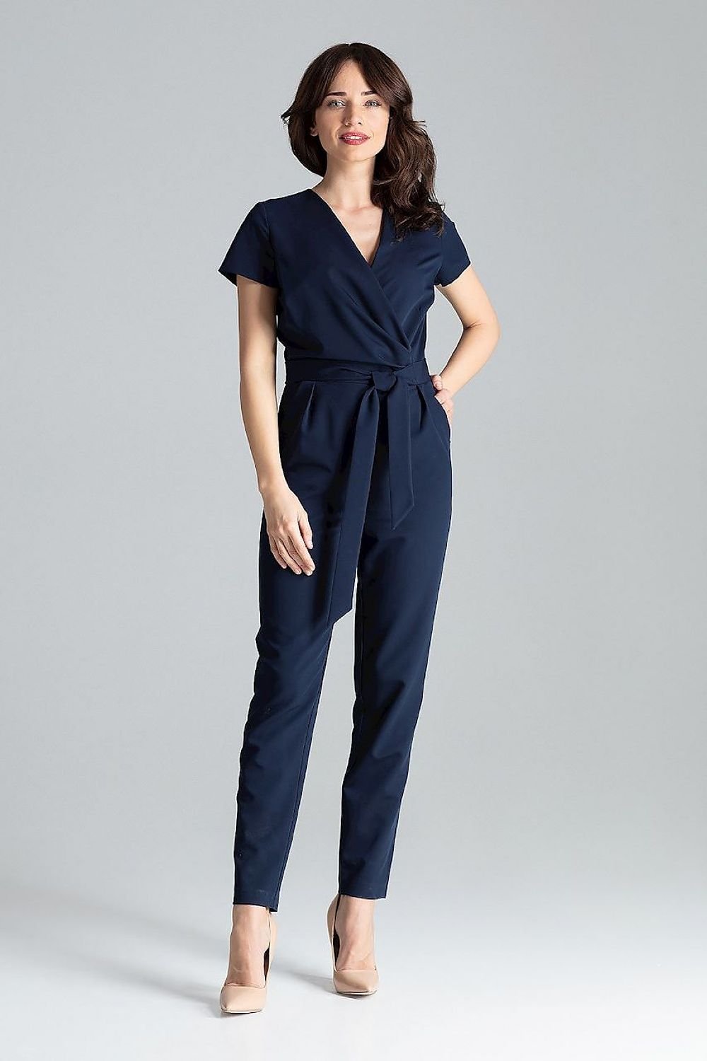 Short-sleeved jumpsuit with loose drape at the waist, tie belt, and long trousers, ideal for a stylish city look.