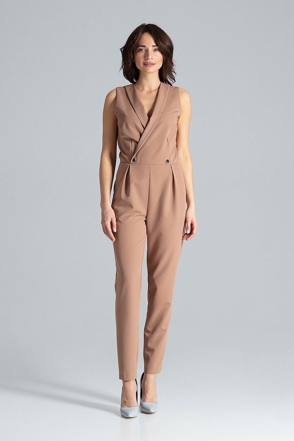 Classic sleeveless jumpsuit with lined narrow lapels, envelope neckline, decorative silver-colored metal snap fasteners, and slanted side pockets.