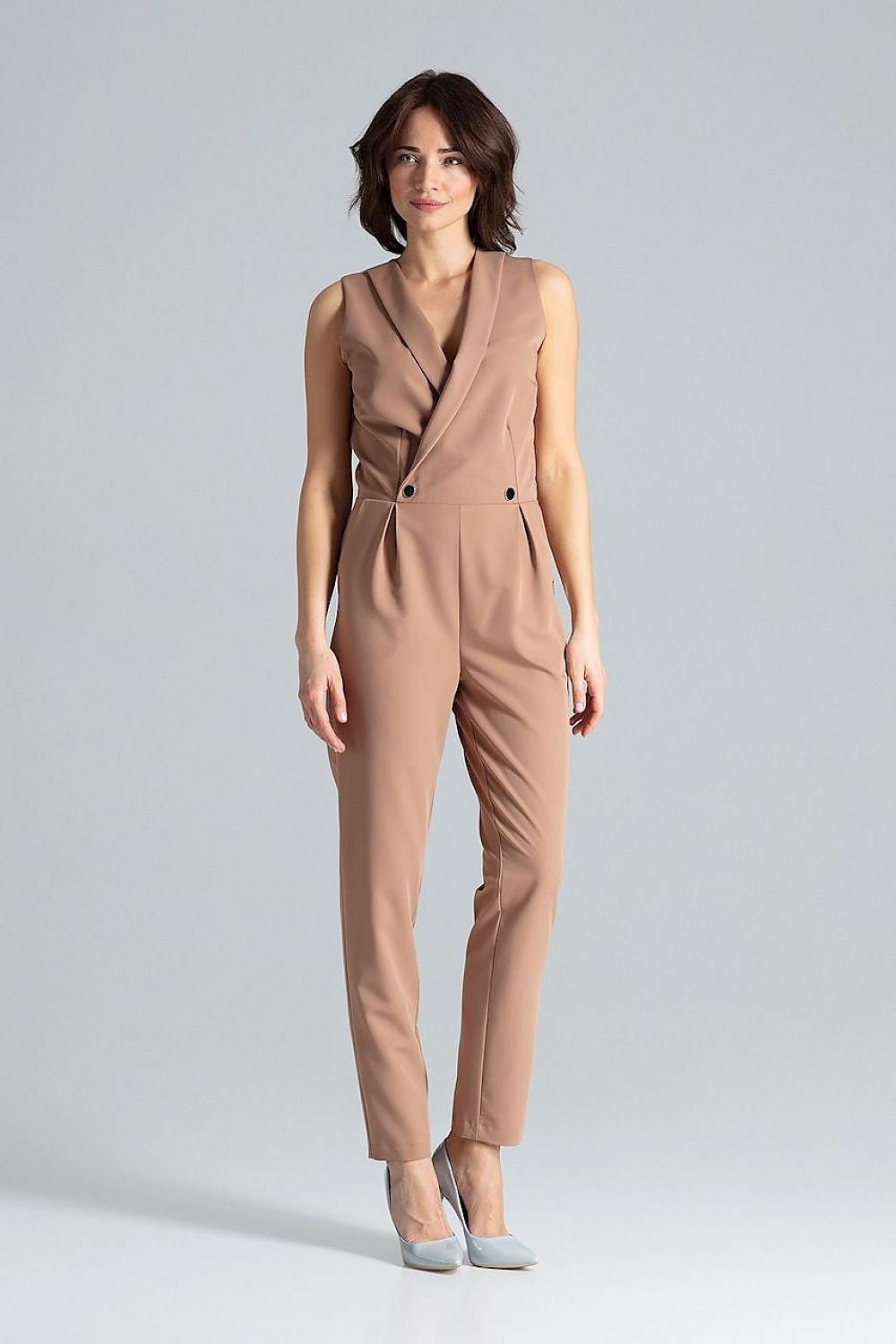 Classic sleeveless jumpsuit with lined narrow lapels, envelope neckline, decorative silver-colored metal snap fasteners, and slanted side pockets.